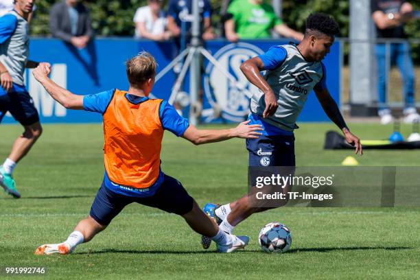 Johannes Geis of Schalke and Weston McKennie of Schalke battle for the ball during a training session at the FC Schalke 04 Training center on July 2,...