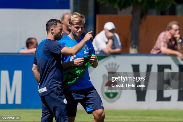 Head coach Domenico Tedesco of Schalke speaks with Johannes Geis of Schalke during a training session at the FC Schalke 04 Training center on July 2,...