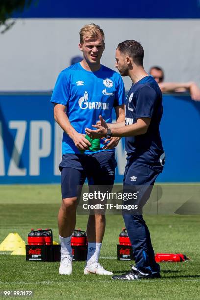 Head coach Domenico Tedesco of Schalke speaks with Johannes Geis of Schalke during a training session at the FC Schalke 04 Training center on July 2,...