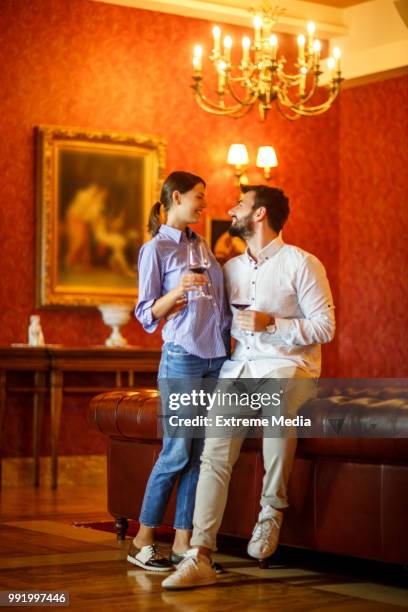 couple on first class trip - chesterfield sofa stock pictures, royalty-free photos & images