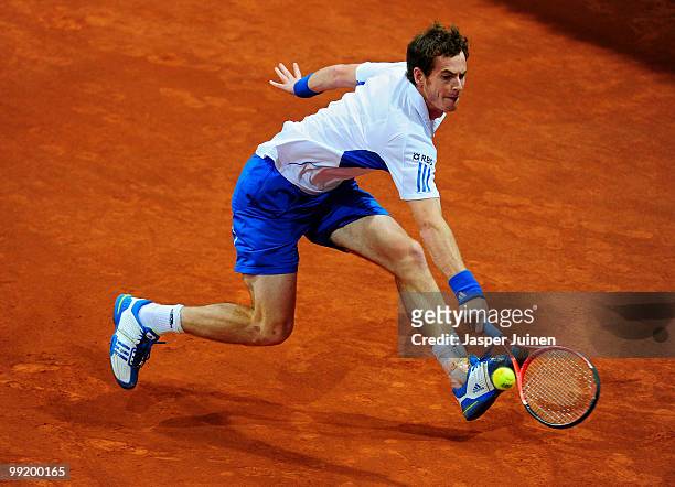 Andy Murray jumps to play a backhand to Victor Hanescu of Romania in their third round match during the Mutua Madrilena Madrid Open tennis tournament...