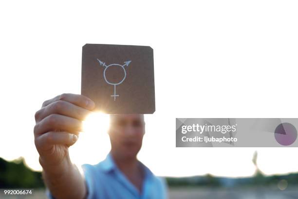 photo of a man and transgender symbol - transgender awareness week stock pictures, royalty-free photos & images