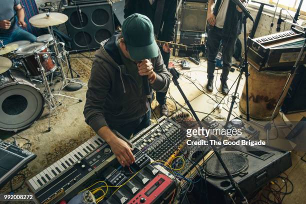 musician standing with musical instruments - synthesizer stock-fotos und bilder