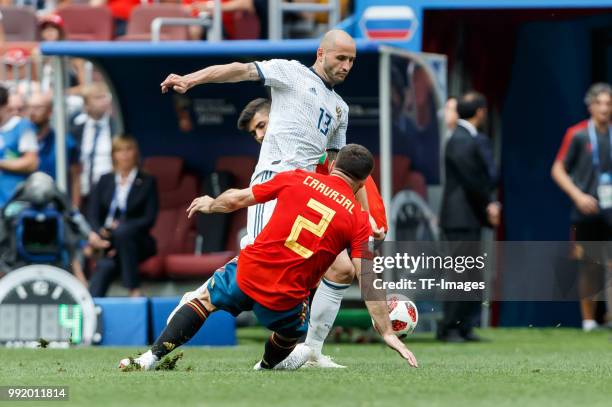 Feder Kudriashov of Russia and Dani Carvajal of Spain battle for the ball during the 2018 FIFA World Cup Russia match between Spain and Russia at...