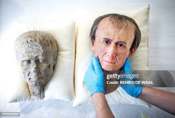 This photograph taken on June 21 shows an assistant holding a 3D reconstruction of Roman emperor and military general Julius Caesar at The National...