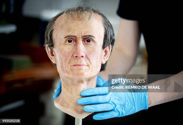 This photograph taken on June 21 shows an assistant holding a 3D reconstruction of Roman emperor and military general Julius Caesar at The National...