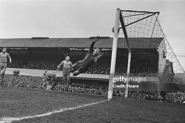Scottish professional footballer and goalkeeper with Wolverhampton Wanderers Dave MacLaren dives in vain as Coventry score the winning goal in the...