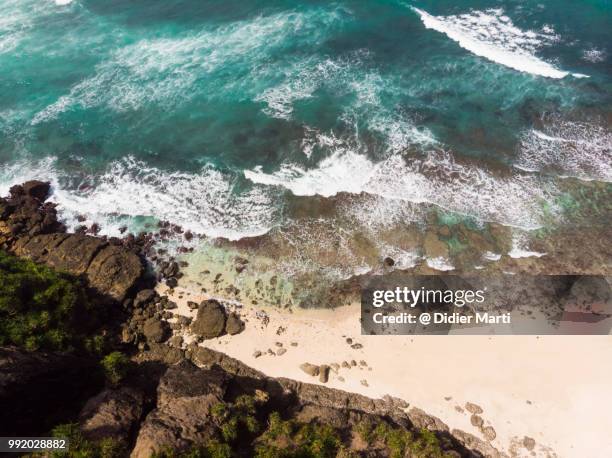 bird eye view of an isolated beach by a rugged coastline near tanjung aan and kuta in south lombok in indonesia - didier marti stock pictures, royalty-free photos & images