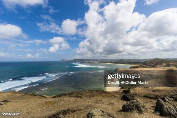 stunning view of the south lombok coast toward kuta from the marese hill by the tanjung aan bay in lombok in indonesia - didier marti stock pictures, royalty-free photos & images