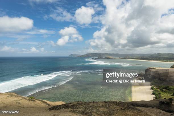 stunning view of the south lombok coast toward kuta from the marese hill by the tanjung aan bay in lombok in indonesia - didier marti stock pictures, royalty-free photos & images