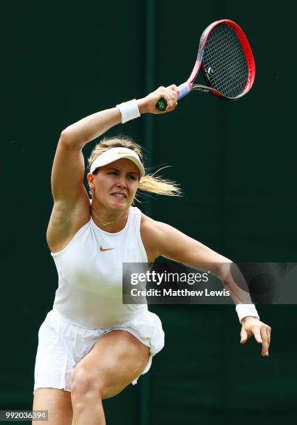 Eugenie Bouchard of Canada returns a shot to Ashleigh Barty of Australia during their Ladies' Singles second round match on day four of the Wimbledon...