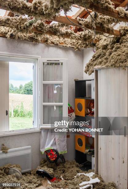 Damaged roof of a house is seen in the village of Saint-Sornin on July 5 after violent hailstorms ripped through the area some 80kms north-west of...