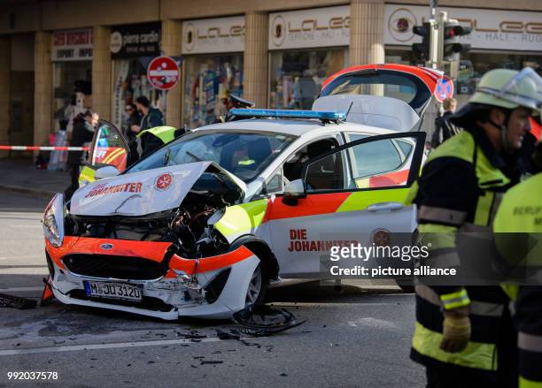 An emergency vehicle of the Johanniter accident relief can be seen after a crash with an SUV on Landwehstrasse street in the district of...