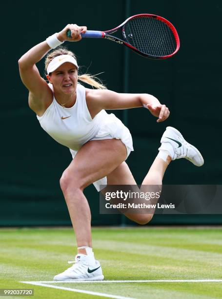 Eugenie Bouchard of Canada returns a shot to Ashleigh Barty of Australia during their Ladies' Singles second round match on day four of the Wimbledon...