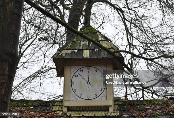 The handles of a painted clock show a few minutes to midnight at an old building on the premises of the former Volkspark Spreepark in Berlin,...