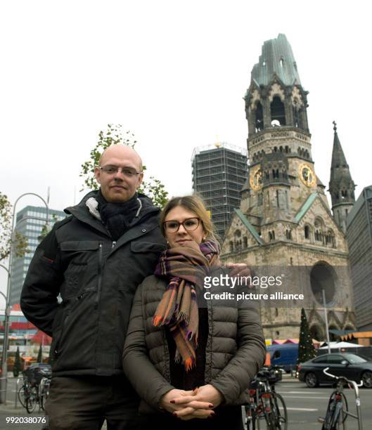 The showmen Max Mueller and his partner Katalina stand in front of the Kaiser Wilhelm Memorial Church in Berlin, Germany, 16 November 2017. The two...
