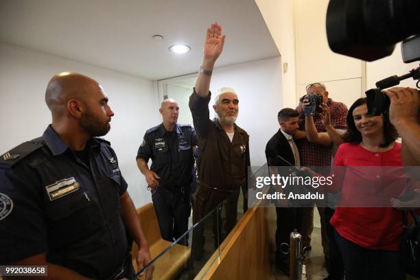Leader of the Northern Branch of the Islamic Movement in Israel, Sheikh Raed Salah raises his hand as he appears in court in Haifa, Israel on July...