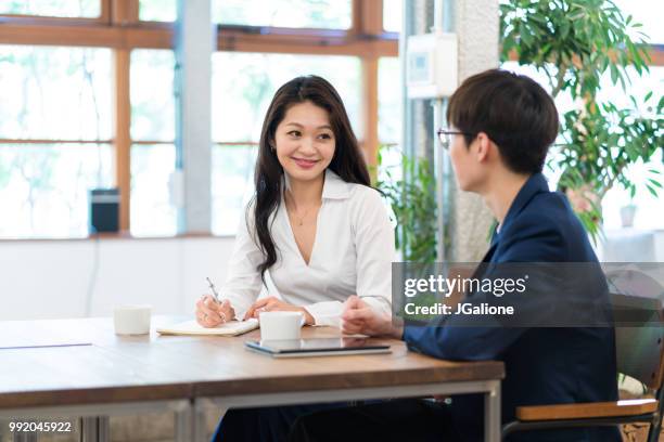 colleagues meeting in a modern office - jgalione stock pictures, royalty-free photos & images