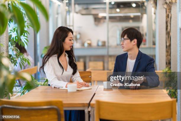 colleagues meeting in a modern office - jgalione stock pictures, royalty-free photos & images