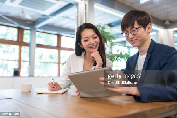 colleagues meeting in a modern office - jgalione stock pictures, royalty-free photos & images