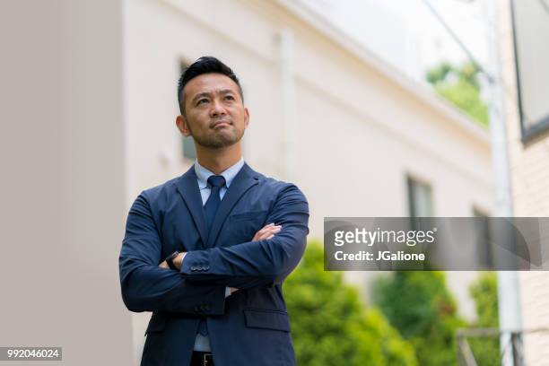 portrait of a confident businessman - jgalione stock pictures, royalty-free photos & images