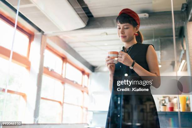 young woman lost in thought - jgalione stock pictures, royalty-free photos & images