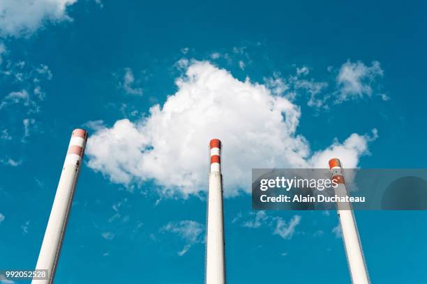 cloud on smokestack in blue sky - air pollution stock pictures, royalty-free photos & images
