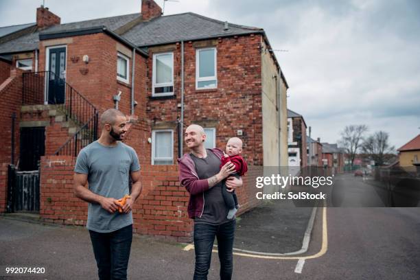 fathers walking with their little boy - cross road children stock pictures, royalty-free photos & images