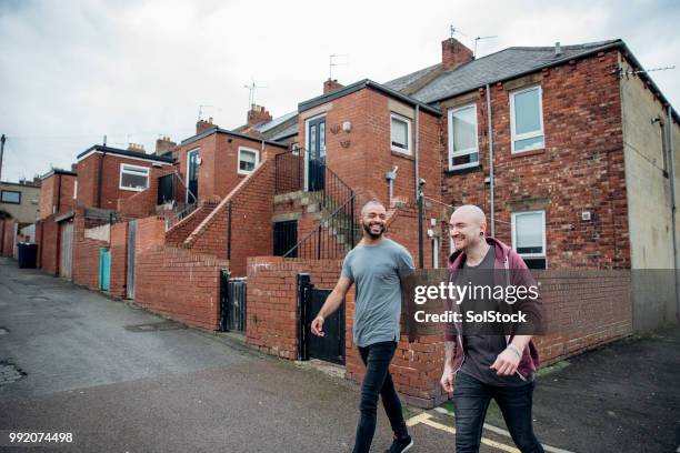 two males walking down the street - skinhead stock pictures, royalty-free photos & images