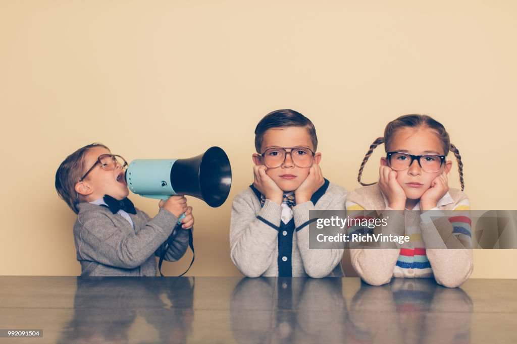 Young Nerd Boy Yelling at Siblings with Megaphone