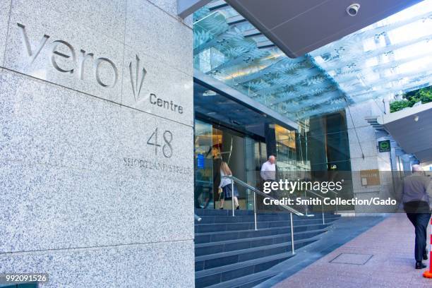 People enter and exit the Vero Centre office building in downtown Auckland, New Zealand, one of Auckland's main commercial properties, February 26,...