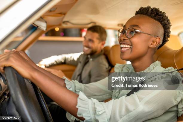 happy young couple inside of car - front passenger seat stock-fotos und bilder