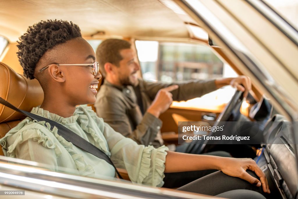 Happy young couple inside of car