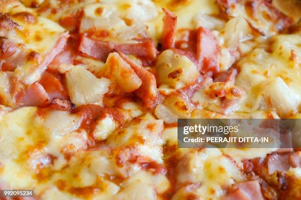 delicious hawaiian rustic style pizza made with fresh pineapples - hawaiian pizza stock pictures, royalty-free photos & images