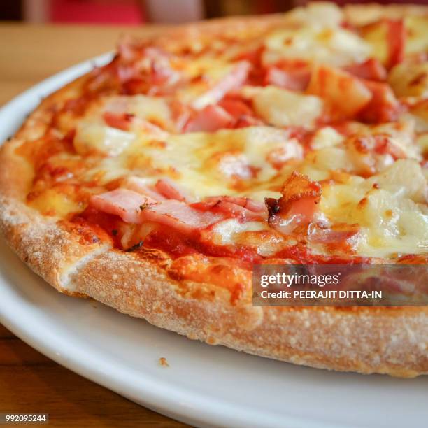 delicious hawaiian rustic style pizza made with fresh pineapples - hawaiian pizza stock pictures, royalty-free photos & images