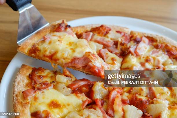 delicious hawaiian rustic style pizza made with fresh pineapples - hawaiian pizza stock pictures, royalty-free photos & images