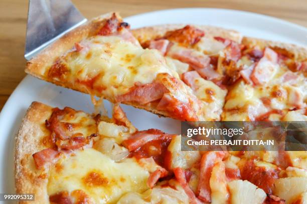 delicious hawaiian rustic style pizza made with fresh pineapples - hawaiian pizza stock pictures, royalty-free photos & images