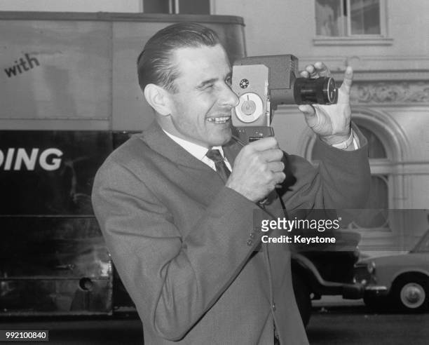 Soviet goalkeeper Lev Yashin uses a cine-camera to capture scenes at his hotel in London, the day before facing England in the Rest of the World...