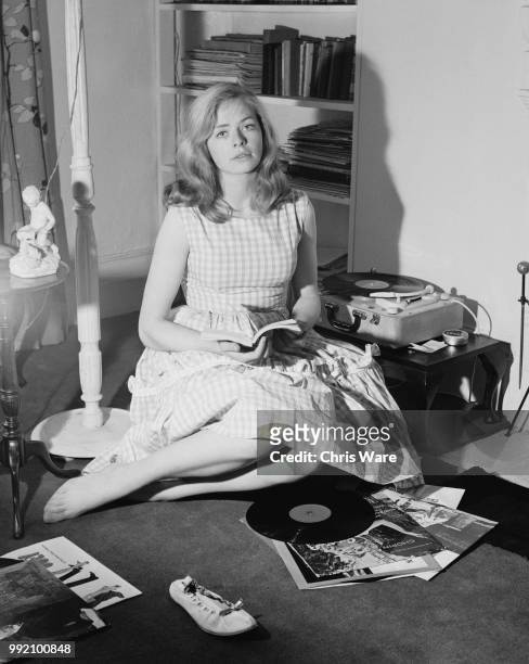 English actress Susannah York playing records at her flat in World's End, Chelsea, London, April 1960.