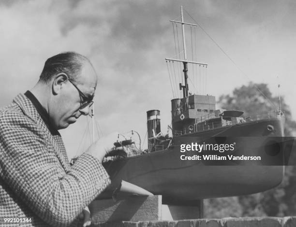 David Carnegie, 11th Earl of Northesk puts the finishing touches to a model of a battleship, 10th October 1938.