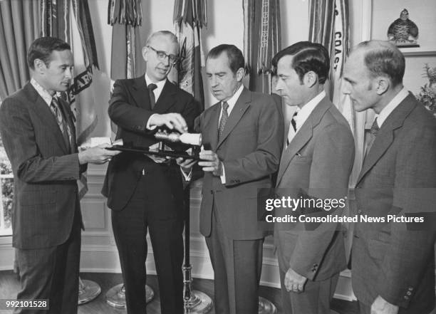 President Richard Nixon is briefed on the upcoming US-Soviet joint space venture by NASA Administrator James C. Fletcher and the Apollo 16 astronauts...