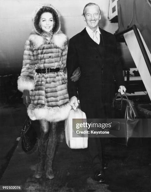 English actor David Niven and his wife Hjordis arrive at Heathrow Airport from Geneva, 13th December 1969. They will be attending a special...