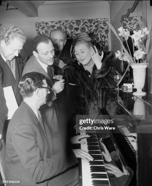 From left to right, Dr Hubert Clifford , musical director for Sir Alexander Korda, comic actor Terry-Thomas , producer Victor Skutezky and actress...