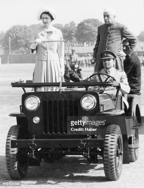 Queen Elizabeth II makes a tour of inspection at a rally of the Indian National Cadet Corps, accompanied by Indian Prime Minister Jawaharlal Nehru ,...