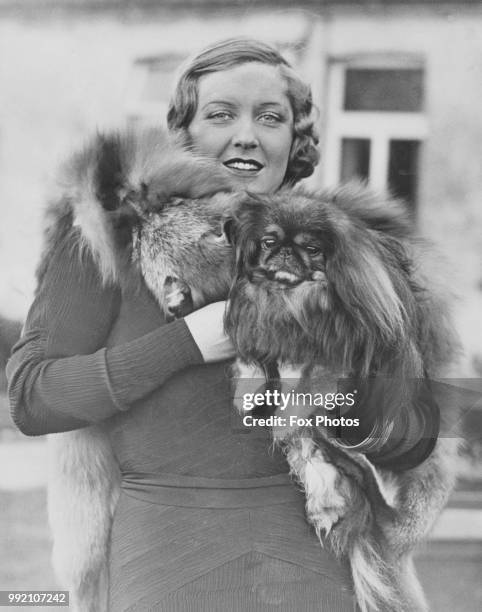 Australian actress Betty Stockfeld with prize Peke Fuchow Paladin, 27th October 1932. They are appearing together in the film 'King of the Ritz'.