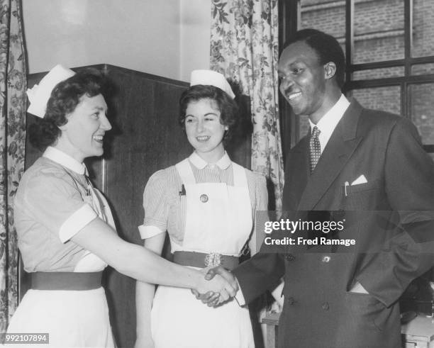 Nigerian politician Raymond Njoku , the Nigerian Federal Minister for Transport, thanks nurses Joan Taylor and Marie Kelly as he leaves the...