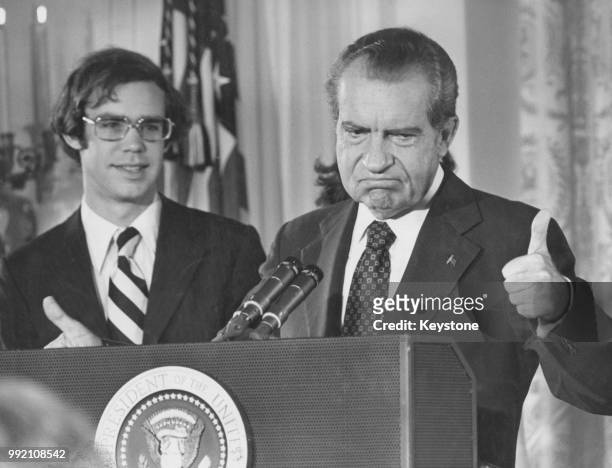 Former US President Richard Nixon gives the thumbs up as he addresses the White House staff upon his resignation as 37th President of the United...