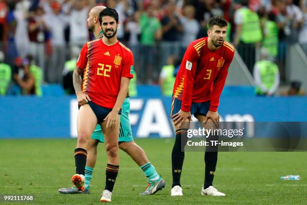 Isco Alarcon of Spain and Gerard Pique of Spain look dejected after the 2018 FIFA World Cup Russia match between Spain and Russia at Luzhniki Stadium...