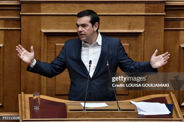 Greece's Prime Minister Alexis Tsipras gestures as he addresses lawmakers at parliament in Athens on July 5 during a debate on the economy and the...