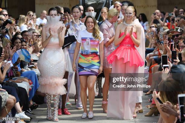 Ashion designer Marina Hoermanseder is applauded by models after her show during the Berlin Fashion Week Spring/Summer 2019 at ewerk on July 5, 2018...